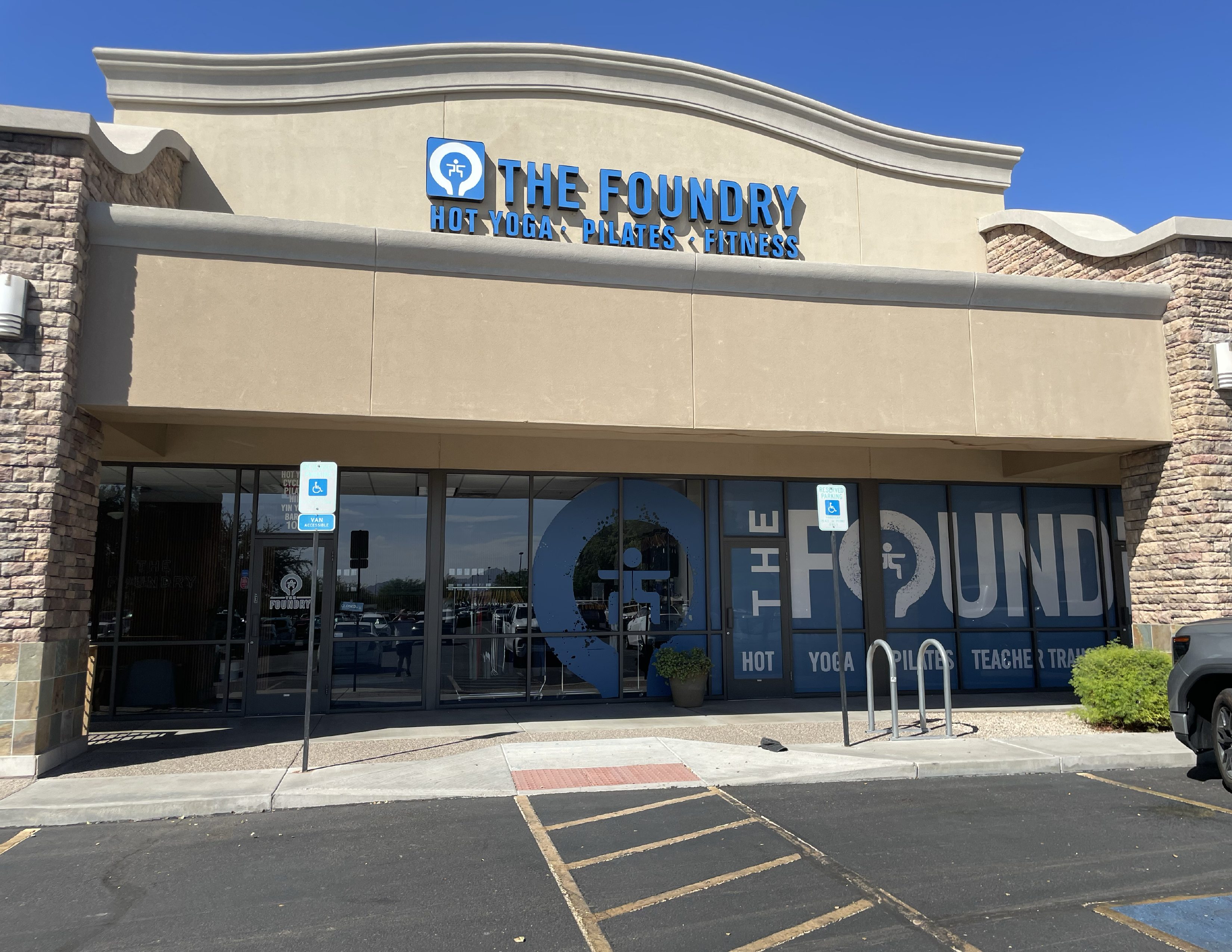 Commercial building exterior in Arizona showing window tinting in progress on multi-pane glass.