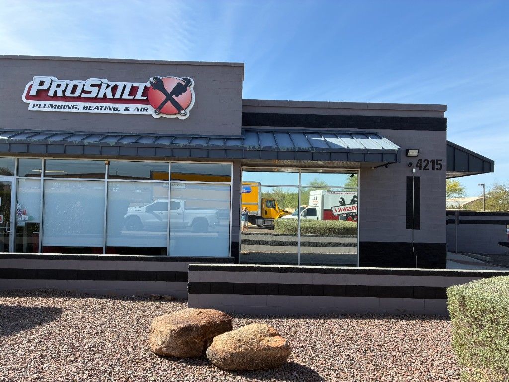 ProSkill Plumbing, Heating & Air commercial building in Arizona with reflective window film on the storefront glass, exterior signage, and desert landscaping in front.